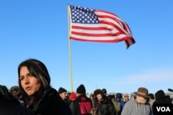 FILE - Hawaii Congresswoman Tulsi Gabbard speaks to the media after addressing veterans near the Standing Rock camp in North Dakota (E. Sarai/VOA)