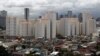 FILE - Rows of condominium buildings are seen behind a middle-class residential district in Mandaluyong, Metro Manila. The economy grew 6.4 percent in the first three months of the year, second only to China, July 4, 2012.