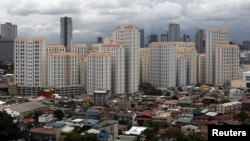 Rows of condominium buildings are seen behind a middle-class residential district in Mandaluyong, Metro Manila. The economy grew 6.4 percent in the first three months of the year, second only to China, July 4, 2012.
