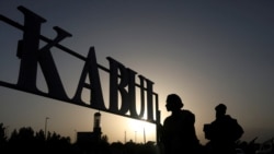 FILE - Taliban soldiers stand in front of a sign at the international airport in Kabul, Afghanistan, September 9, 2021. (West Asia News Agency via Reuters)