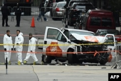 Investigators work around the wreckage of a Home Depot pickup truck a day after it was used in a terror attack in New York, Nov. 1, 2017.