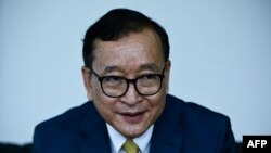 FILE: Cambodia's exiled opposition figurehead Sam Rainsy, who leads the Cambodia National Rescue Party (CNRP), speaks during an interview with Agence France-Presse (AFP)