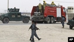 Afghan policemen keep watch during an attack by insurgents at a police training base in Kandahar, April 7, 2011