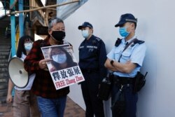 Pro-democracy supporters protest to urge for the release of 12 Hong Kong activists arrested as they reportedly sailed to Taiwan for political asylum and citizen journalist Zhang Zhan outside China's Liaison Office, in Hong Kong, China December 28, 2020. R