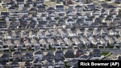 FILE - Rows of homes, are shown outside Salt Lake City. Taken April 13, 2019. 