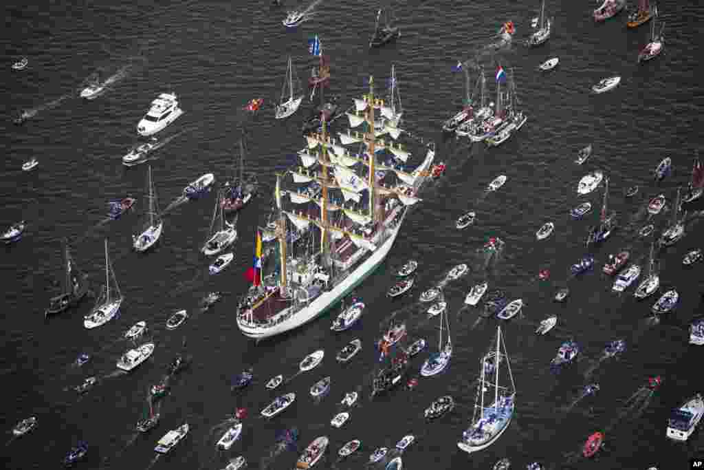 Columbian tall ship ARC Gloria is escorted by small boats as it arrives to participate in SAIL Amsterdam 2015, a five-yearly festival celebrating the Dutch capital&rsquo;s maritime history that is expected to draw some 2 million visitors, in Amsterdam, Netherlands.