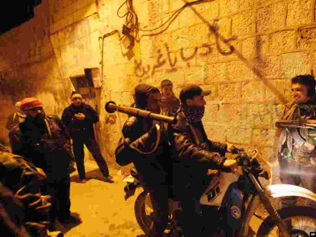 Syrian rebels gather in an alley as they secure a demonstration in Idlib, Syria on February 5, 2012. (AP)