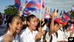 Cambodia students hold the Cambodian national flags as they attend the Independence Day celebration at the Independence Monument in the capital Phnom Penh.
