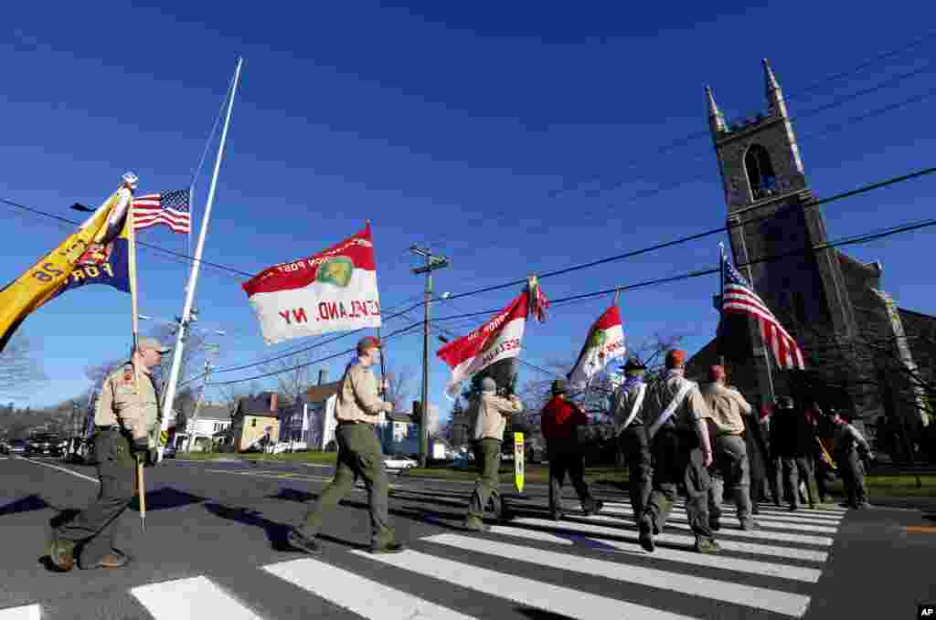 Boy Scouts of America carry flags as they walk toward Trinity Episcopal Church before funeral services for Benjamin Andrew Wheeler, Newton, Connecticut, December 20, 2012.