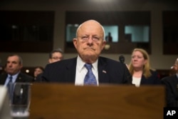 FILE - Then-Director of National Intelligence James Clapper arrives for a Senate Armed Services Committee hearing about worldwide threats, on Capitol Hill in Washington, Feb. 9, 2016.