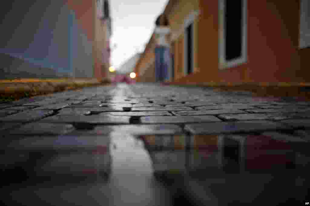 A wet, cobblestone street is seen during a rainy day in Old San Juan, Puerto Rico, November 4. Heavy rains caused by a cluster of storms killed at least seven people in Haiti and caused major flooding in the Dominican Republic and Puerto Rico. 