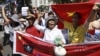 Protesters hold banners while chanting slogans during an anti-China protest along a street in Hanoi, July 22, 2012.