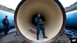Un policía vigila una tubería de drenaje en las afueras de la prisión del Altiplano, en Almoloya, al oeste de la Ciudad de México.
