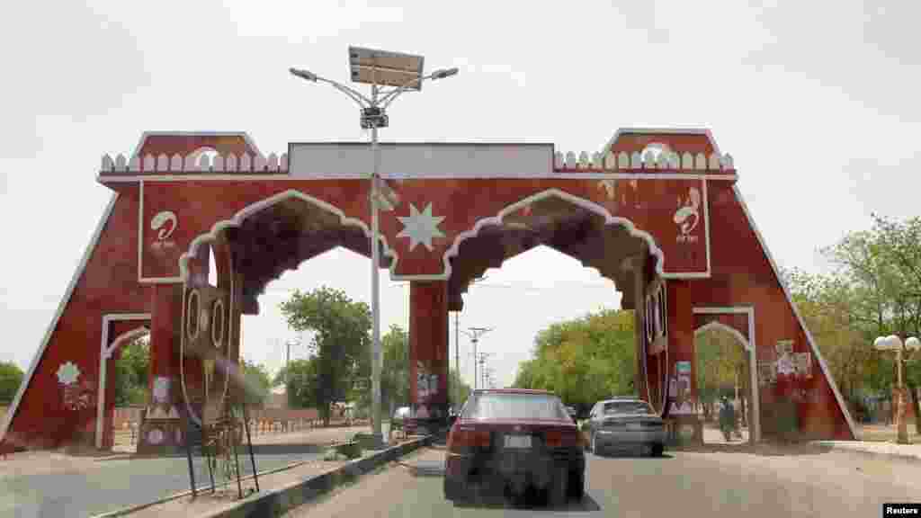 Vehicles drive through the city gate located along Jos Road, after the military declared a 24-hour curfew over large parts of Maiduguri in Borno State May 19, 2013.