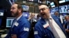 Floor governor Peter Giacchi (R) gives a price for Noble Midstream Partners LP, during the company's IPO on the floor of the New York Stock Exchange (NYSE) in New York City, Sept. 15, 2016. 