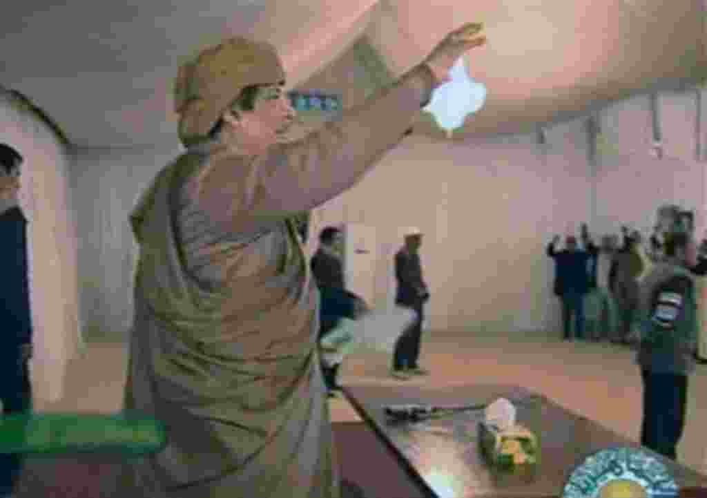 This video image broadcast on Libyan state television Sunday Feb. 20, 2011 shows longtime Libyan leader Moammar Gadhafi appearing with numerous supporters at various events in Tripoli in the evening Saturday Feb. 19, 2011. Women and children were seen amo