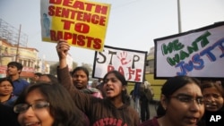 ndian students protesting against the brutal gang-rape of a woman on a bus last week in New Delhi, hold placards during a protest in Allahabad, India, Dec. 26, 2012