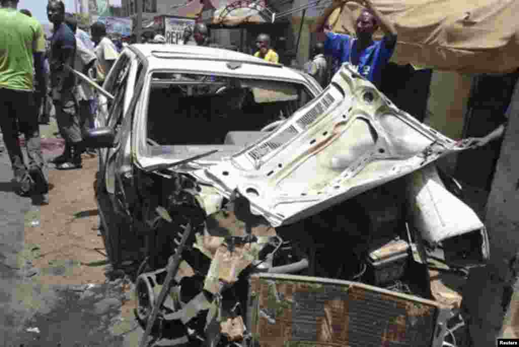 The wreckage of a car is pictured after a bomb blast in front of the office compound of Nigerian newspaper This Day in the northern city of Kaduna April 26, 2012.
