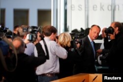 FILE - German conservative Friedrich Merz arrives for a news conference about his candidacy to succeed Chancellor Angela Merkel as leader of the Christian Democrats, in Berlin, Germany, Oct. 31, 2018.