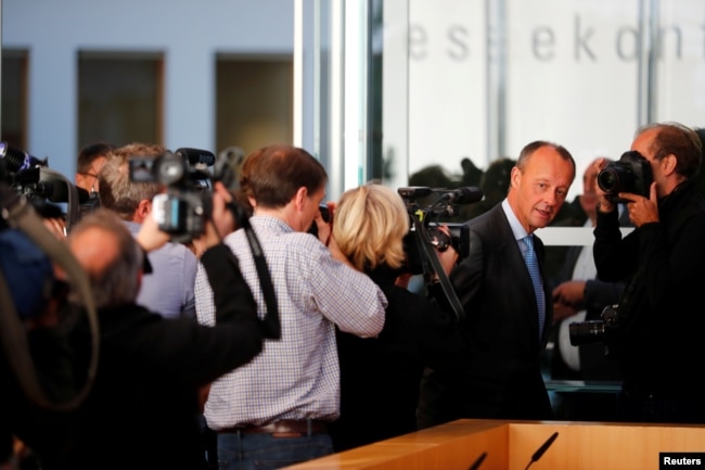 FILE - German conservative Friedrich Merz arrives for a news conference about his candidacy to succeed Chancellor Angela Merkel as leader of the Christian Democrats, in Berlin, Germany, Oct. 31, 2018.