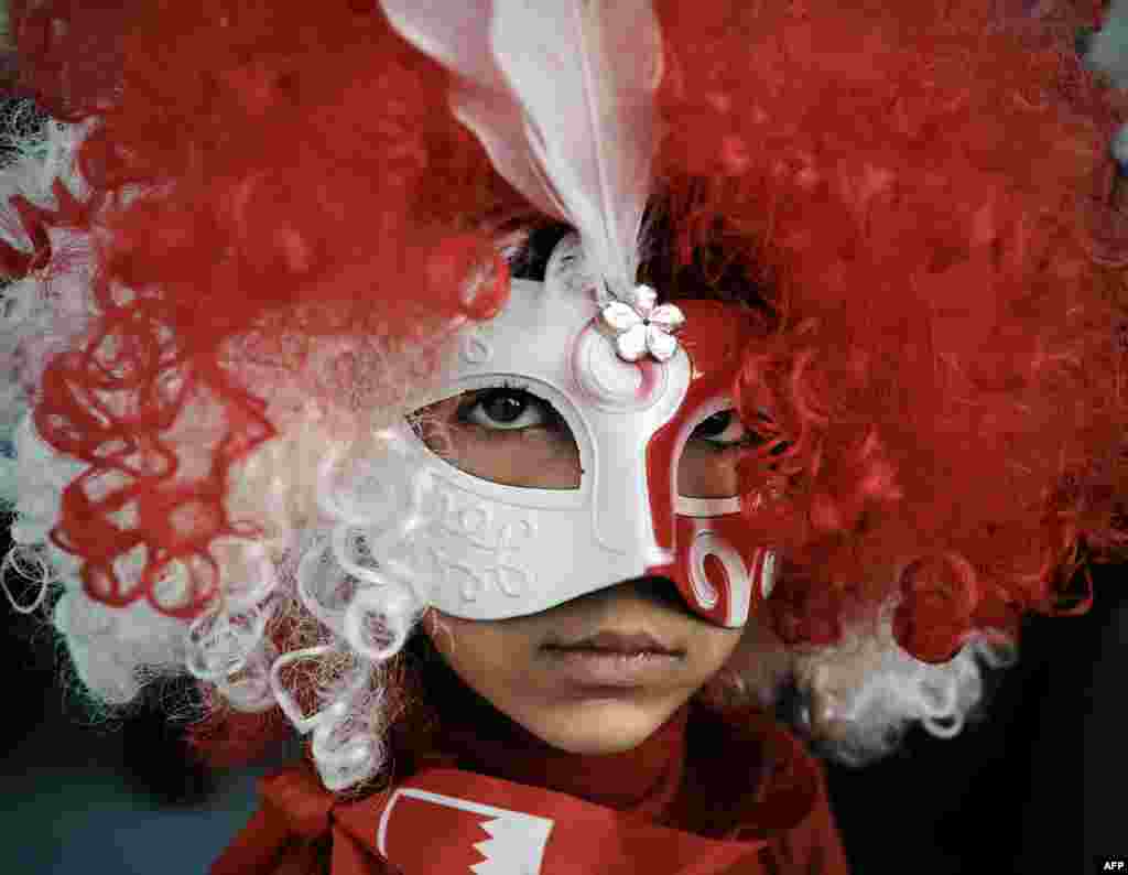 A young Bahraini girl wearing a mask poses during an anti-government protest in the village of Shakhora, west of Manama.