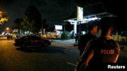 Indonesian police guard is seen near the scene of a shooting in Sleman, Yogyakarta, Indonesia July 14, 2018.