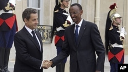 France's President Nicolas Sarkozy, left, welcomes Rwandan's President Paul Kagame, right, at the Elysee Palace. Kagame has warned outside powers against trying to "manage Africa" during a visit to France aimed at soothing tensions over the 1994 genocide 