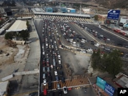 Drivers wait to cross the Mexico-U.S. border from Tijuana, Mexico, Nov. 19, 2018. The United States closed off northbound traffic for several hours at the busiest border crossing with Mexico to install new security barriers.
