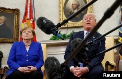 FILE - U.S. President Donald Trump meets with German Chancellor Angela Merkel in the Oval Office in Washington, April 27, 2018.