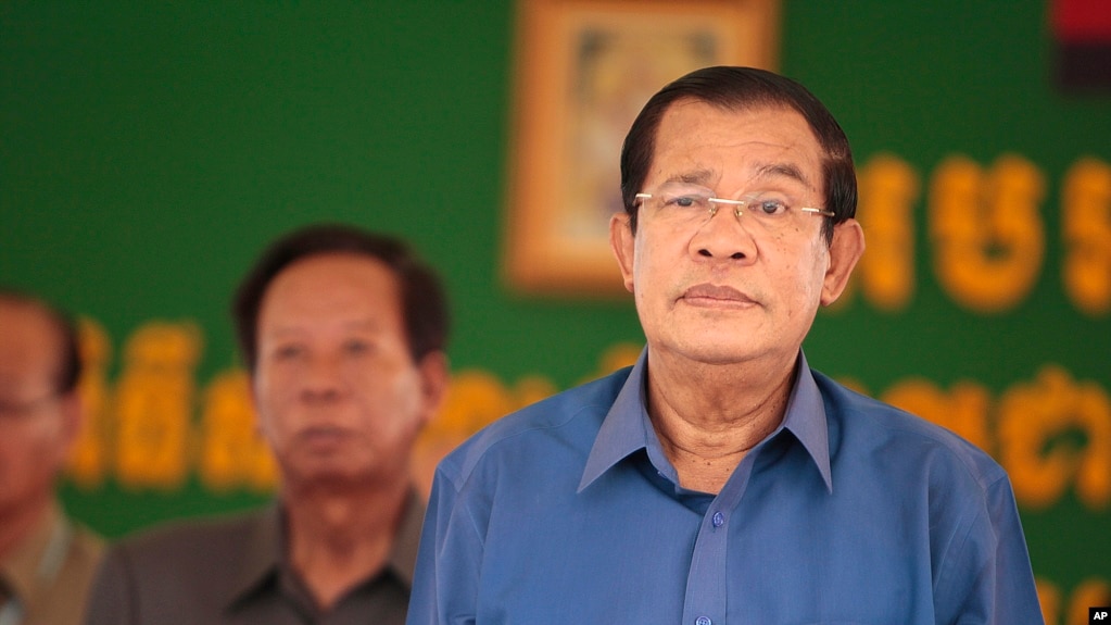 FILE: Cambodia's Prime Minister Hun Sen, right, prepares to deliver a speech during a factory visit outside of Phnom Penh, Cambodia, Aug. 30, 2017.