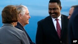 U.S. Secretary of State Rex Tillerson (L) is greeted by Ethiopia Minister of Foreign Affairs, Workneh Gebeyehu (R), and other officials, as he arrives to begin a six-day trip in Africa, after landing at Addis Ababa International Airport, March 7, 2018 in 