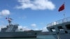 China’s replenishment ship, Qiandaohu, left, sails past its hospital ship, Peace Ark, as it docks in Honolulu, Hawaii. 