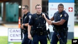 Police guard the emergency room entrance of Our Lady Of The Lake Medical Center, where wounded officers were brought, in Baton Rouge, Louisiana, July 17, 2016. 