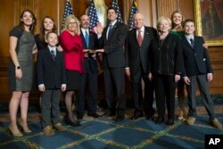 Liz Cheney acompañada de su familia es juramentada como legisladora de Wyoming, por el presidente de la Cámara de Representantes Paul Ryan. Enero 3 de 2017.