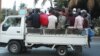One of Maputo's many truck taxis packed full of commuters during the end of day rush hour, August 2012, (VOA/Jinty Jackson)