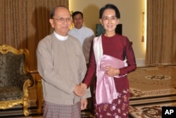 FILE - In this image provided by the Myanmar Ministry of Information, Myanmar President Thein Sein, left, shakes hands with opposition leader Aung San Suu Kyi during their meeting at the presidential in Naypyitaw, Myanmar, Dec. 2, 2015.