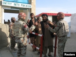 Pakistani soldiers check the identity of citizens returning from Afghanistan at the border town of Chaman, Pakistan, March 7, 2017.