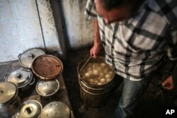 A man prepares meals for his family on the eve of Shabbath, at Hara Kbira, on the island of Djerba, southern Tunisia, Oct. 30, 2015..