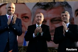 FILE - Recep Tayyip Erdogan, center, who was then Turkey's prime minister; his Albanian counterpart, Edi Rama, left; and then-Kosovar counterpart Hashim Thaci clap during a visit to Prizren, southwest of capital, Pristina, Oct. 23, 2013.