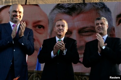 FILE - Recep Tayyip Erdogan, center, who was then Turkey's prime minister; his Albanian counterpart, Edi Rama, left; and then-Kosovar counterpart Hashim Thaci clap during a visit to Prizren, southwest of capital, Pristina, Oct. 23, 2013.