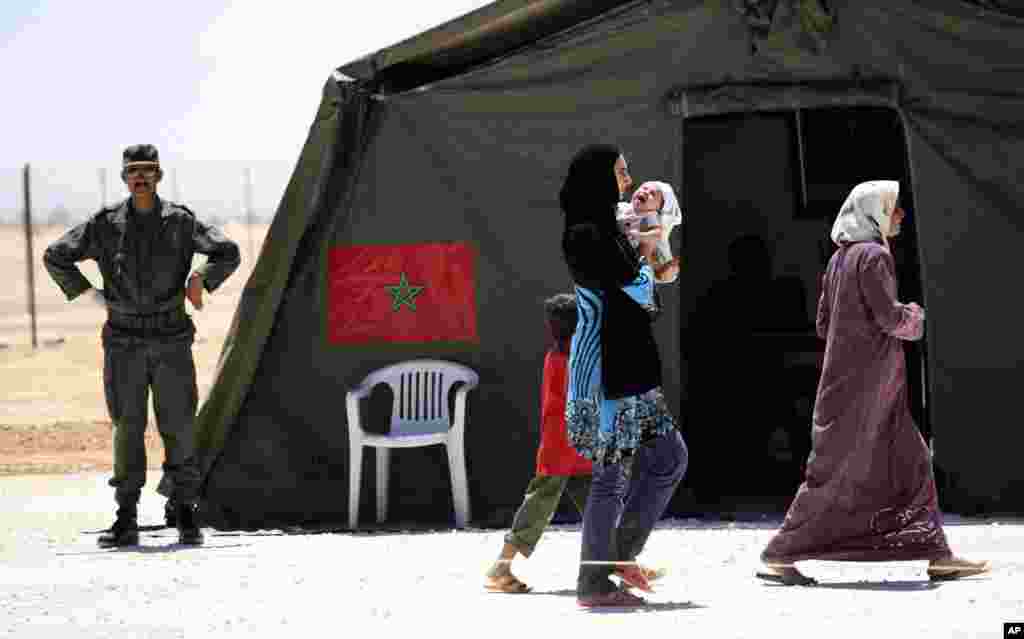 Syrian refugees after the medical check at a Moroccan military field hospital in Zaatari refugee camp in Mafraq, Jordan, Aug. 10, 2012. 