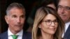 FILE - Actress Lori Loughlin, front, and husband, clothing designer Mossimo Giannulli, left, depart federal court in Boston after facing charges in a nationwide college admissions bribery scandal, Apr. 3, 2019.