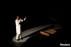 FILE - Aamir Liaquat Hussain recites religious rhyme during a live show in Karachi, Pakistan, July 26, 2013.