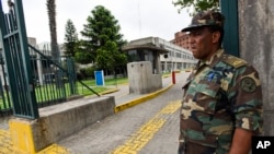 A soldier stands guard at the entrance of a military hospital in Montevideo, where six former Guantanamo Bay prisoners are undergoing medical checks after being resettled in Uruguay, Dec. 8, 2014. 