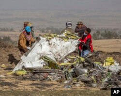 Rescuers work at the scene of an Ethiopian Airlines flight crash near Bishoftu, or Debre Zeit, south of Addis Ababa, Ethiopia, Monday, March 11, 2019.