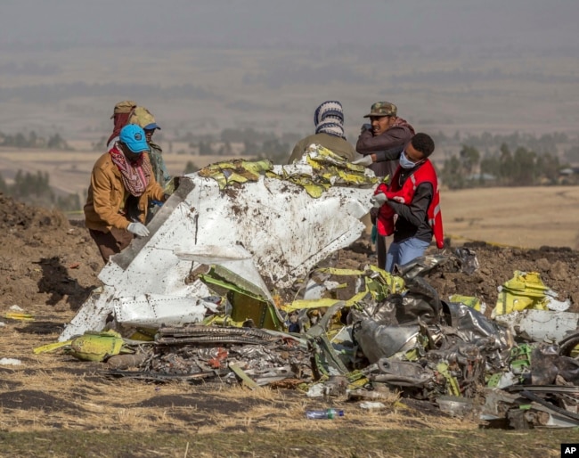 Rescuers work at the scene of an Ethiopian Airlines flight crash near Bishoftu, or Debre Zeit, south of Addis Ababa, Ethiopia, Monday, March 11, 2019.