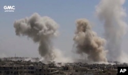 This frame grab from video provided on Aug. 13, 2017, shows smoke and debris rising after Syrian government ground-to-ground rocket strike on the Ain Terma, in the Eastern Ghouta suburb of Damascus.
