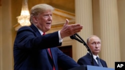 FILE - President Donald Trump points out as he speaks as Russian President Vladimir Putin watches their joint press conference at the Presidential Palace in Helsinki, Finland, July 16, 2018.
