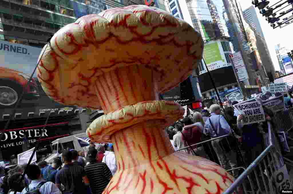 An inflatable mushroom cloud is carried by demonstrators at a rally opposing the nuclear deal with Iran, in Times Square, July 22, 2015.