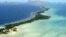 This March 30, 2004, file photo, shows Tarawa atoll, Kiribati. Rising sea levels caused by global warming threaten the very existence of their tiny Pacific nation of Kiribati, one of the lowest-lying countries on Earth. (AP Photo/Richard Vogel, File)